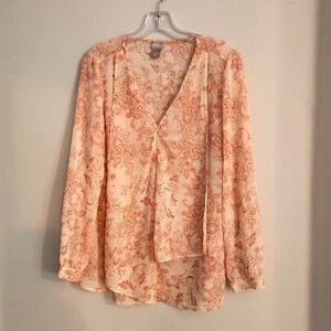 This dressy feminine layered in front blouse has silky flowing feel and look to